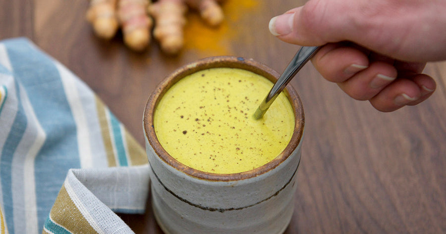 Stirring Golden Milk in mug