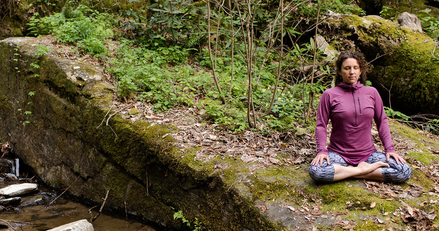 Anna Levesque meditating in the woods