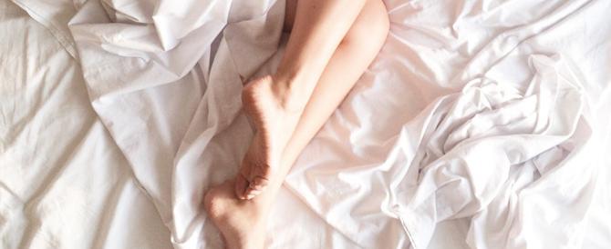 Woman's legs laying in bed