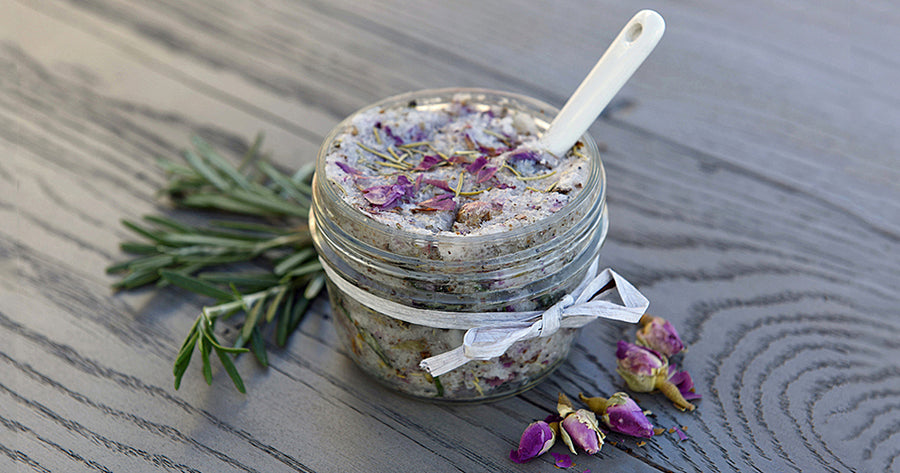 DIY Coconut scrub in jar with pine needles and flower petals to side