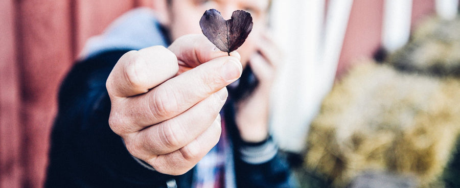 Man holding heart shaped leaf