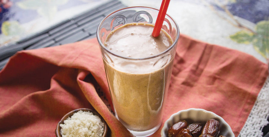 Salted Cacao Caramel Smoothie in glass with dates on side