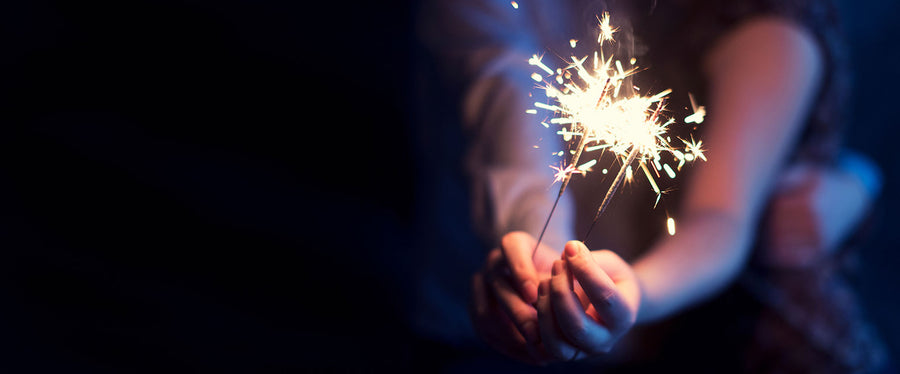 Couple holding sparkler firecracker