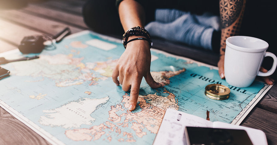 Woman pointing at North America on world map