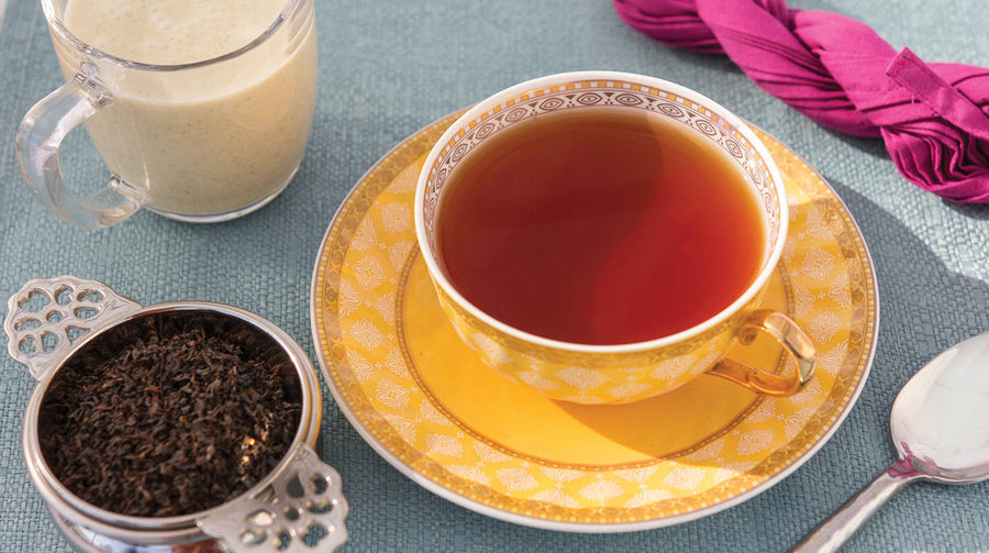 Turmeric Chai Tea in mug with condiments on side