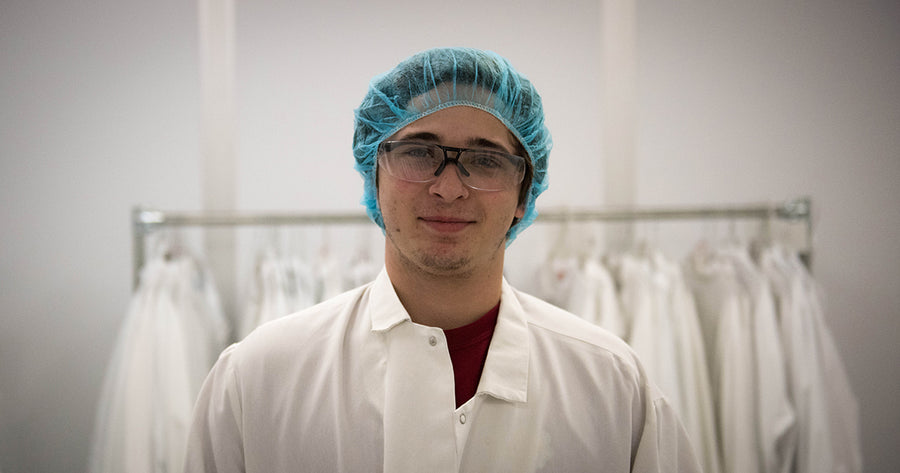 Gaia team member in lab gown and cap