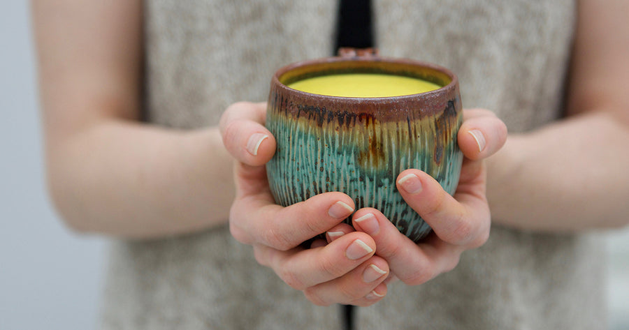 Woman holding mug of Golden Milk